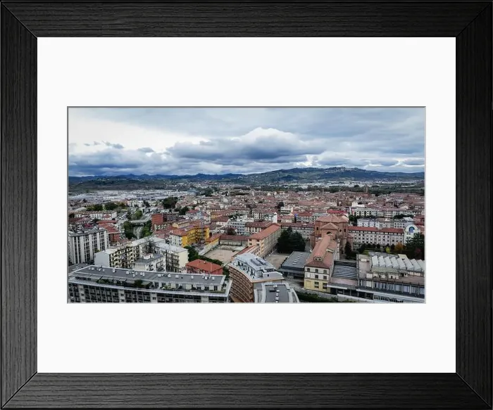 Framed Print : The skyline of Alba, Italy, reveals a blend of historic architecture and modern structures under an overcast sky Framed Print : The skyline of Alba, Italy, reveals a blend of historic architecture and modern structures under an overcast sky