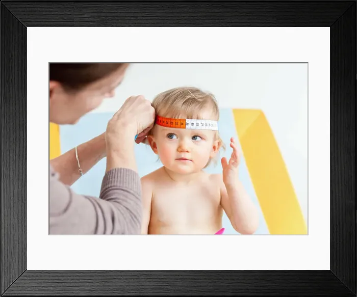 Framed Print : Measurement of the circumference of a 14-month-old baby's head (cranial perimeter) with a tape measure Framed Print : Measurement of the circumference of a 14-month-old baby's head (cranial perimeter) with a tape measure