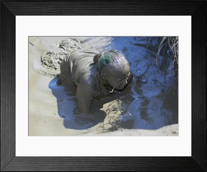 Framed Print : A young girl is covered from head to toe in mud, after participating in a muddy obstacle event Framed Print : A young girl is covered from head to toe in mud, after participating in a muddy obstacle event