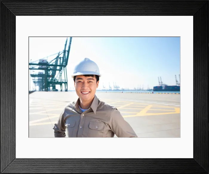 Framed Print : Male shipping industry worker with hands on hips with shipping dock background Framed Print : Male shipping industry worker with hands on hips with shipping dock background