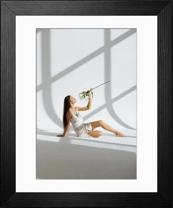 Framed Print : Young beautiful woman with flowers peonies. A girl sits on the floor with flowers. Flowers cover the body Framed Print : Young beautiful woman with flowers peonies. A girl sits on the floor with flowers. Flowers cover the body