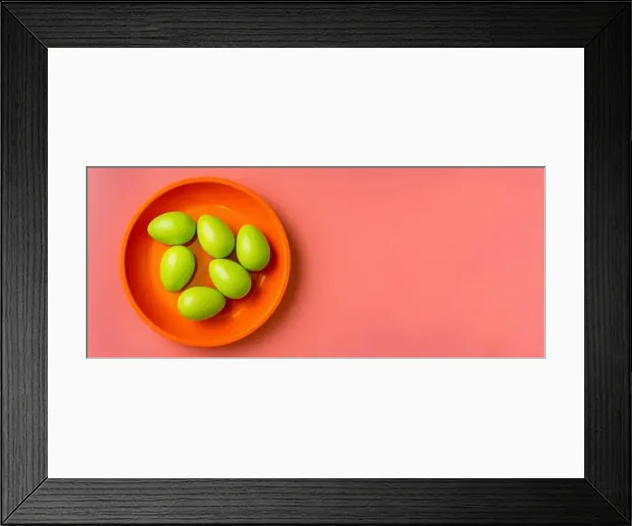 Framed Print : Top view of green Easter eggs in a bright plate on vibrang orange and red background Framed Print : Top view of green Easter eggs in a bright plate on vibrang orange and red background