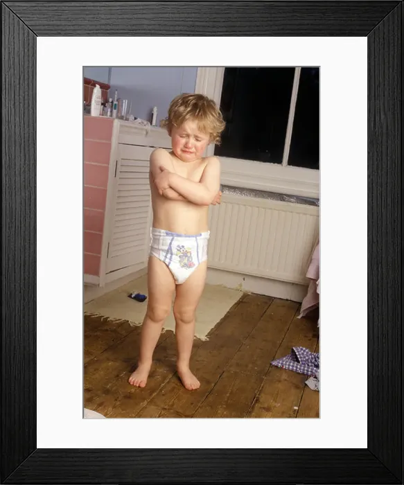 Framed Print : little boy standing in pull-ups in the bathroom looking miserable Framed Print : little boy standing in pull-ups in the bathroom looking miserable