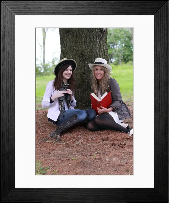 Framed Print : two fashionable teenagers bird watching with guide and binoculars Framed Print : two fashionable teenagers bird watching with guide and binoculars