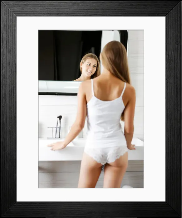 Framed Print : Beautiful young woman standing in her bathroom getting ready Framed Print : Beautiful young woman standing in her bathroom getting ready