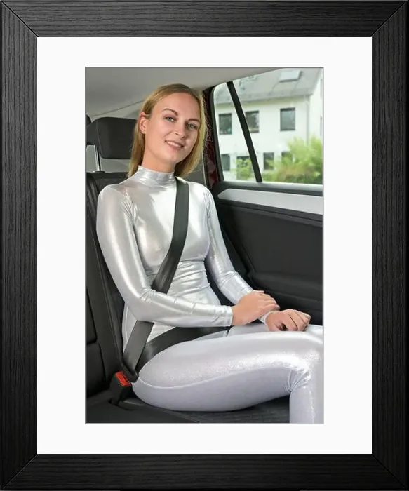 Framed Print : Young woman wearing a catsuit buckled up in the backseat of a car Framed Print : Young woman wearing a catsuit buckled up in the backseat of a car