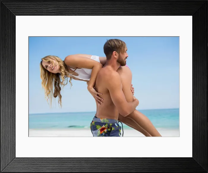 Framed Print : Side view of man carrying girlfriend while standing at beach against clear sky Framed Print : Side view of man carrying girlfriend while standing at beach against clear sky