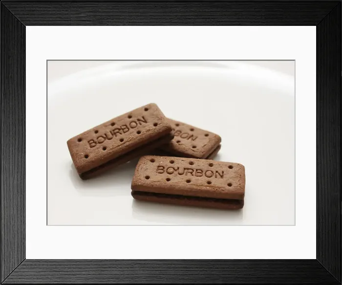 Framed Print : Three Bourbon biscuits arranged on a white plate Framed Print : Three Bourbon biscuits arranged on a white plate