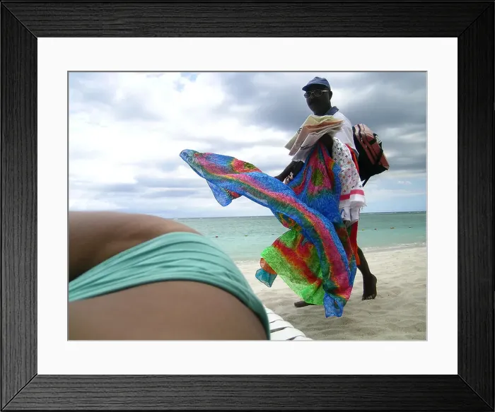 Framed Print : Woman in bikini sunbathing at beach as beach hawker passes by, Mauritius Framed Print : Woman in bikini sunbathing at beach as beach hawker passes by, Mauritius