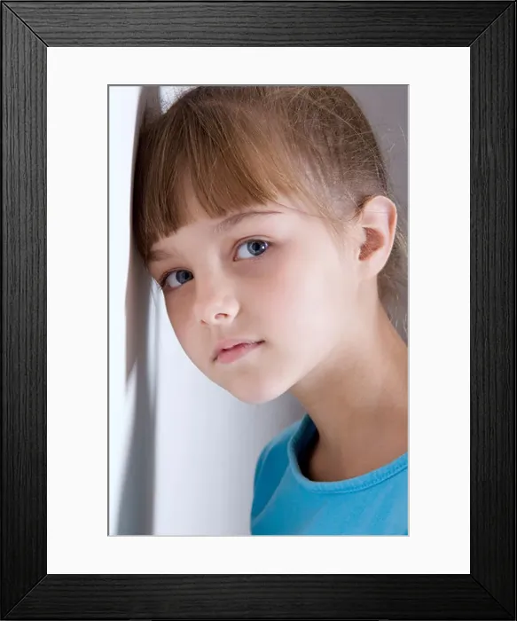 Framed Print : Portrait of girl (8-9) leaning against wall Framed Print : Portrait of girl (8-9) leaning against wall