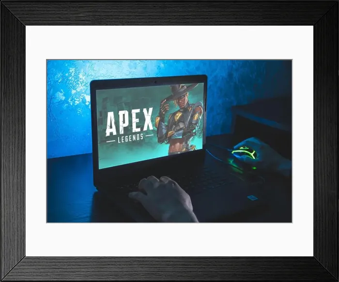 Framed Print : Apex Legends is a free-to-play battle royale-hero shooter game. Video computer game. Man play video game on laptop Framed Print : Apex Legends is a free-to-play battle royale-hero shooter game. Video computer game. Man play video game on laptop
