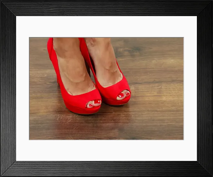 Framed Print : Female fashion. Closeup red high heels spiked fashionable shoes on female legs Framed Print : Female fashion. Closeup red high heels spiked fashionable shoes on female legs