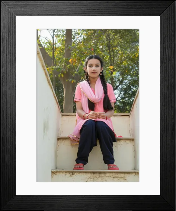 Framed Print : Young village girl sitting on the steps of her house leading to the terrace Framed Print : Young village girl sitting on the steps of her house leading to the terrace