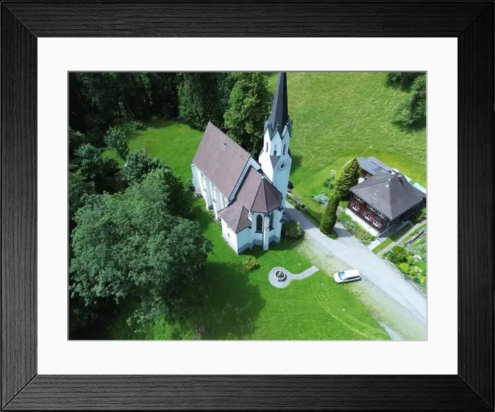 Framed Print : An aerial view of Kuratienkirche Meschach surrounded by lush greenery. Gotzis, Austria