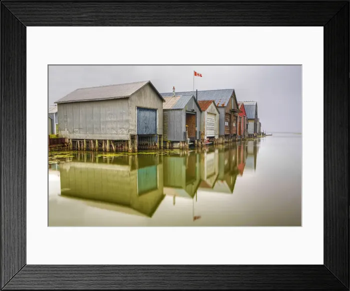 Framed Print : Boathouse and their reflection in a small harbor in Port Rowan, Ontario, Canada Framed Print : Boathouse and their reflection in a small harbor in Port Rowan, Ontario, Canada