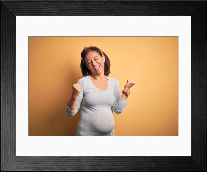 Framed Print : Middle age pregnant woman expecting baby at aged pregnancy very happy and excited doing winner gesture with arms raised Framed Print : Middle age pregnant woman expecting baby at aged pregnancy very happy and excited doing winner gesture with arms raised