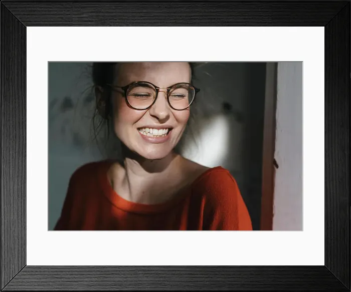 Framed Print : Portrait of happy young woman with glasses Framed Print : Portrait of happy young woman with glasses