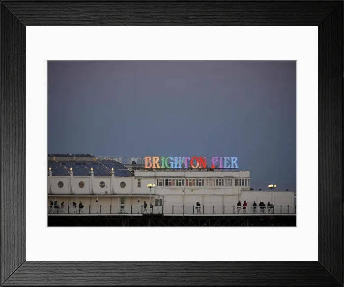 Framed Print : Brighton Pier lit like a rainbow at night in England Framed Print : Brighton Pier lit like a rainbow at night in England