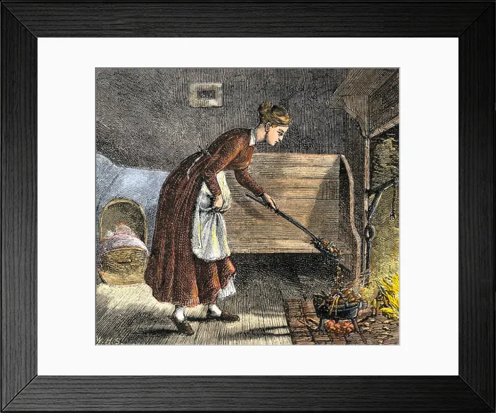 Framed Print : Pioneer mother cooking with a bake-kettle in the fireplace. Hand-colored woodcut Framed Print : Pioneer mother cooking with a bake-kettle in the fireplace. Hand-colored woodcut