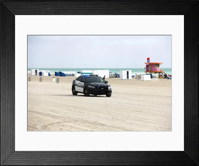 Framed Print : A police car parked at the sandy beach of Miami, Florida, USA Framed Print : A police car parked at the sandy beach of Miami, Florida, USA