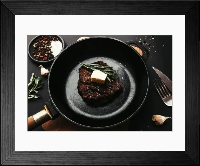 Framed Print : Cooked ribeye steak on cast-iron pan and board with pepper Framed Print : Cooked ribeye steak on cast-iron pan and board with pepper