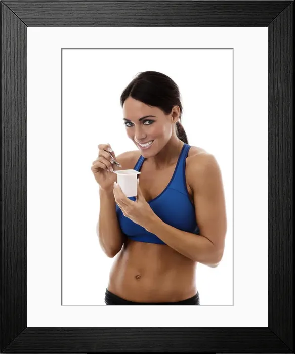 Framed Print : fitness woman wearing sports bra eating yogurt Framed Print : fitness woman wearing sports bra eating yogurt