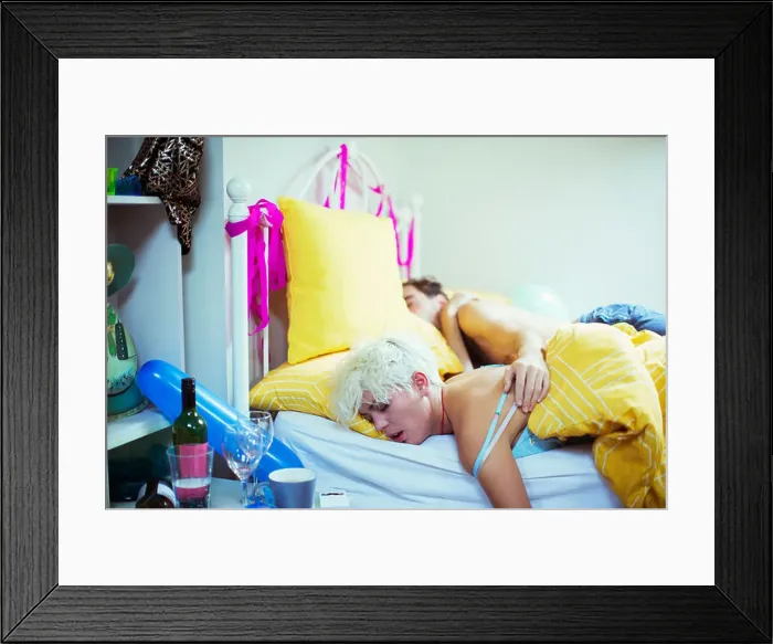 Framed Print : Couple sleeping in bed the morning after a party Framed Print : Couple sleeping in bed the morning after a party