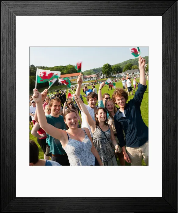 Framed Print : a group of happy laughing young people waving welsh banners flags, wales Framed Print : a group of happy laughing young people waving welsh banners flags, wales
