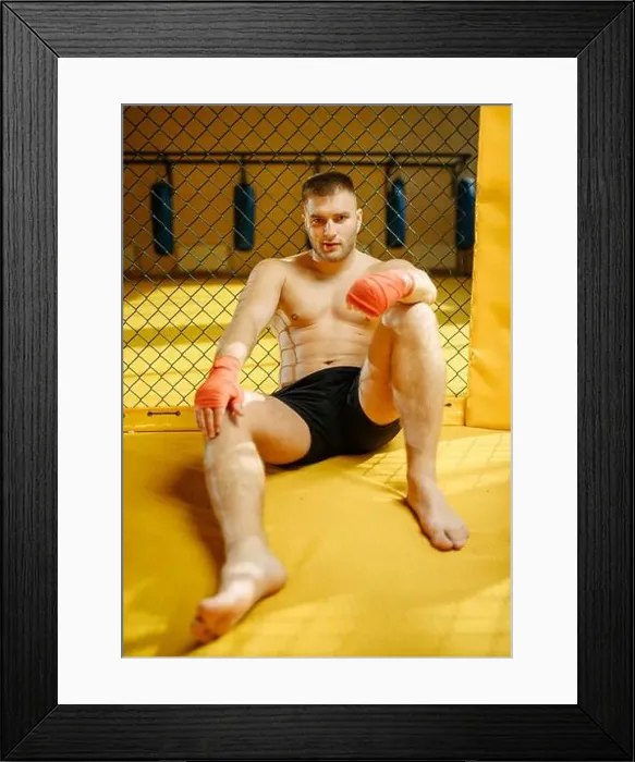 Framed Print : Male MMA fighter sitting on the floor in a cage Framed Print : Male MMA fighter sitting on the floor in a cage