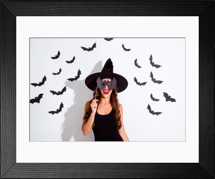 Framed Print : Trick or threat Close up portrait of cheerful woman with curly Framed Print : Trick or threat Close up portrait of cheerful woman with curly