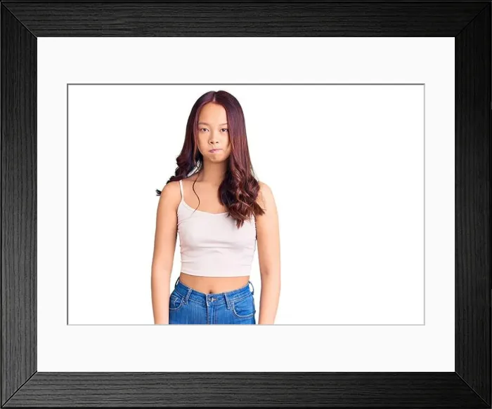 Framed Print : Young beautiful chinese girl wearing casual clothes puffing cheeks with funny face Framed Print : Young beautiful chinese girl wearing casual clothes puffing cheeks with funny face