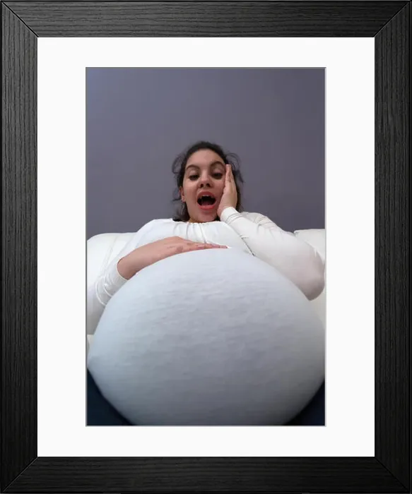 Framed Print : Humorous shocked reaction of pregnant mom to her big growing tummy Framed Print : Humorous shocked reaction of pregnant mom to her big growing tummy
