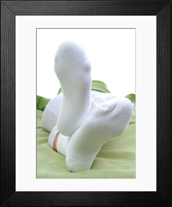 Framed Print : Woman lying wearing white socks Framed Print : Woman lying wearing white socks