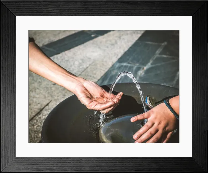 Framed Print : Water of a fountain pouring in woman hand Framed Print : Water of a fountain pouring in woman hand