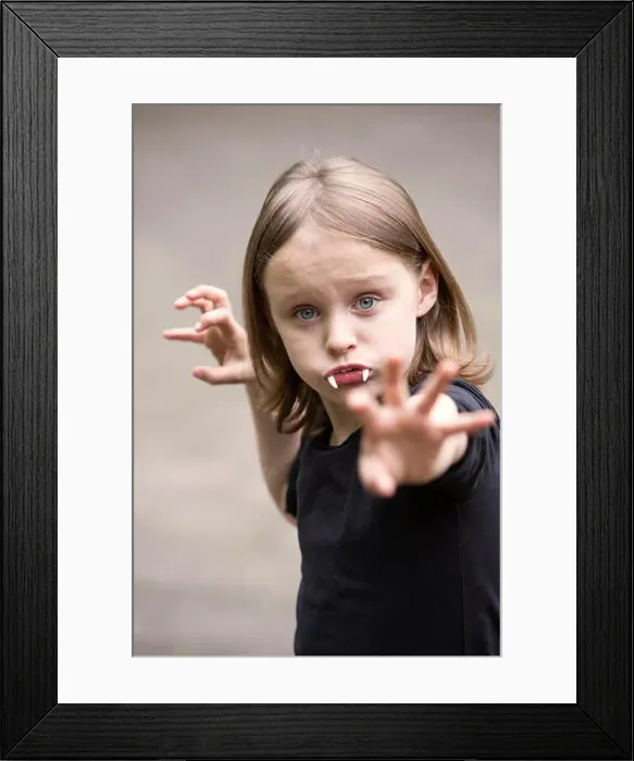Framed Print : portrait of blond boy with vampire teeth looking at camera Framed Print : portrait of blond boy with vampire teeth looking at camera