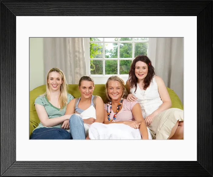 Framed Print : Four young women seated on couch Framed Print : Four young women seated on couch