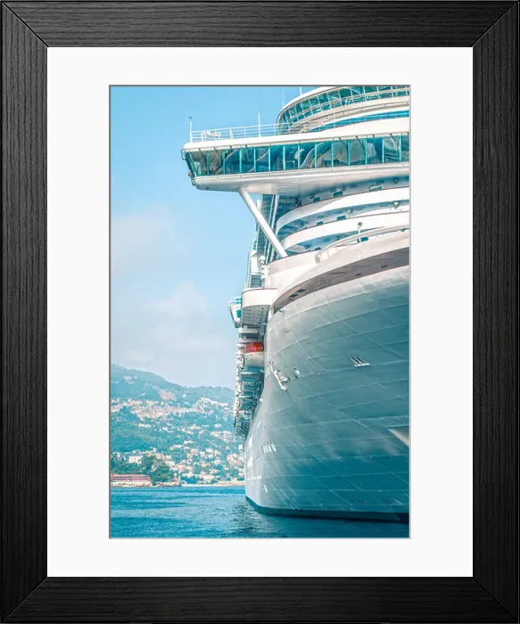 Framed Print : Front detail of large luxury cruise ship in clear blue water with city in background. Comfortable cruise or voyage Framed Print : Front detail of large luxury cruise ship in clear blue water with city in background. Comfortable cruise or voyage