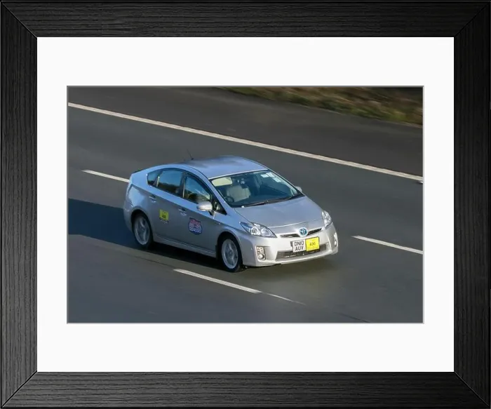 Framed Print : 2010 Toyota Prius T Spirit Vvt-I Cvt Silver Hybrid Electric taxi car driving on the M6 motorway near Preston Framed Print : 2010 Toyota Prius T Spirit Vvt-I Cvt Silver Hybrid Electric taxi car driving on the M6 motorway near Preston