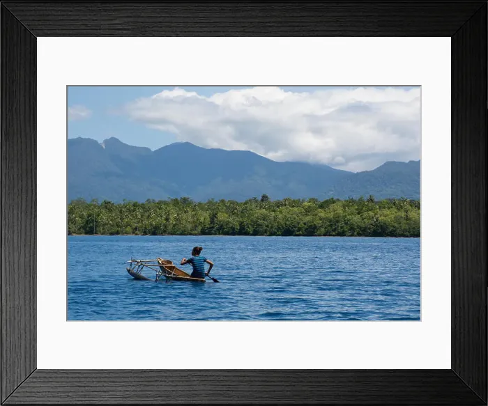 Framed Print : Melanesia, Papua New Guinea, Fergusson Island. Villager in traditional dugout canoe