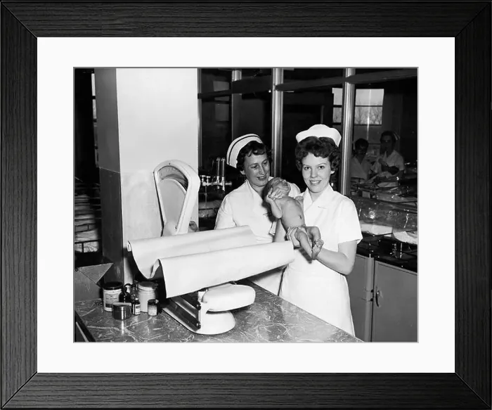 Framed Print : Two nurses with baby in nursery at Toronto East General and Orthopaedic Hospital, Toronto, ON Framed Print : Two nurses with baby in nursery at Toronto East General and Orthopaedic Hospital, Toronto, ON