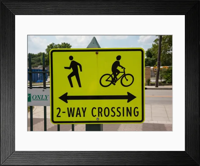 Framed Print : Sign warning of a pedestrian and bicycle crossing