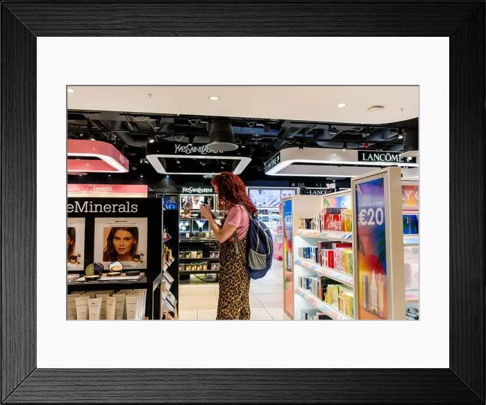 Framed Print : A woman looks at perfume on sale at Dublin Airport duty free store. Ireland Framed Print : A woman looks at perfume on sale at Dublin Airport duty free store. Ireland