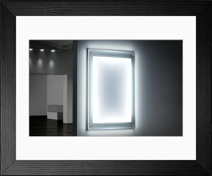 Framed Print : Blank white illuminated poster mockup in dark hall