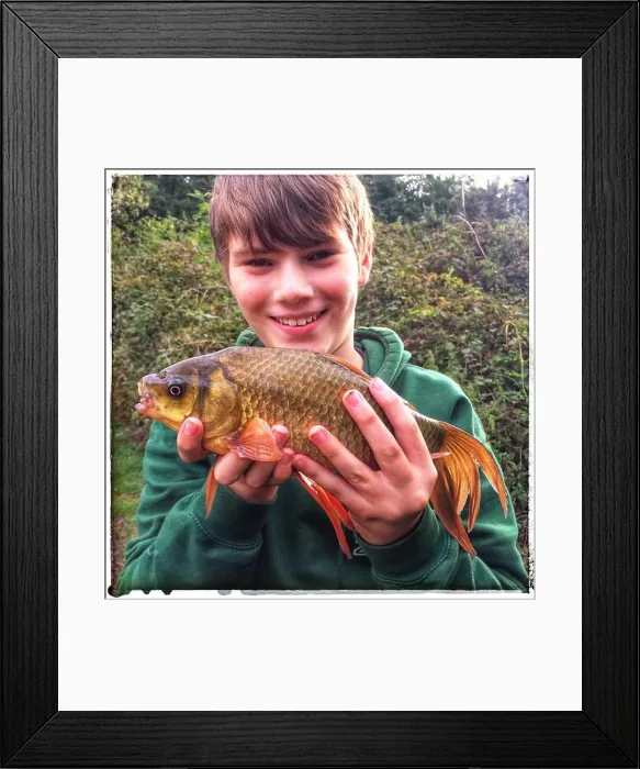 Framed Print : Young angler holding carp Framed Print : Young angler holding carp