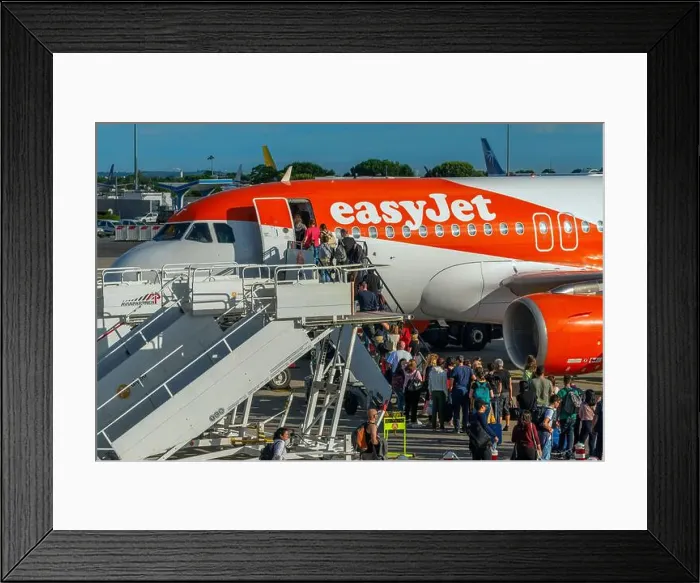 Framed Print : Close profile view of an Easy Jet Airbus A320 with boarding passengers Framed Print : Close profile view of an Easy Jet Airbus A320 with boarding passengers