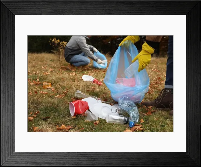 Framed Print : People with trash bags collecting garbage in nature, closeup Framed Print : People with trash bags collecting garbage in nature, closeup