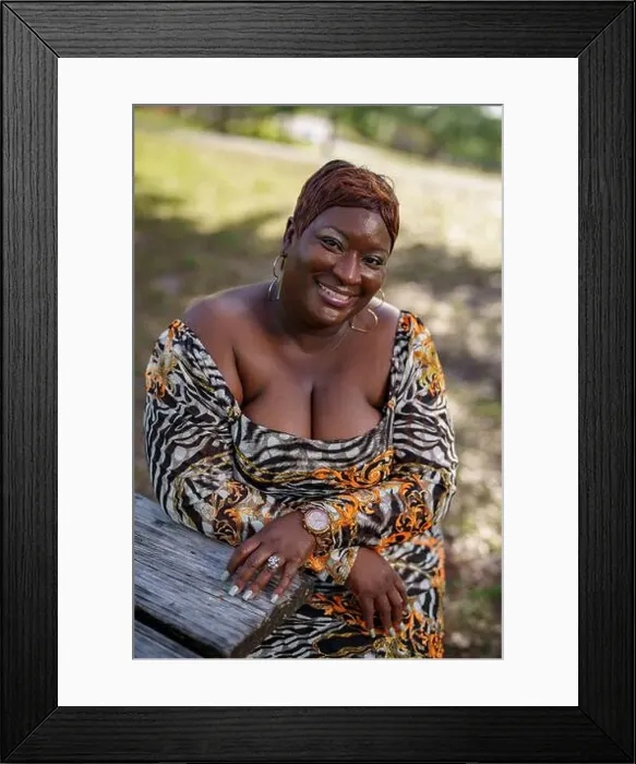 Framed Print : BBW big black beautiful model sitting on a park bench outdoors