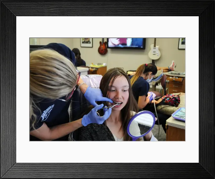 Framed Print : An orthodontist is a type of dentist who specializes in straightening crooked teeth