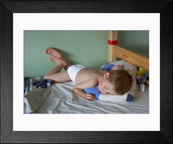 Framed Print : Young boy child asleep sleeping in bed in an unusual positiion CJWH Framed Print : Young boy child asleep sleeping in bed in an unusual positiion CJWH