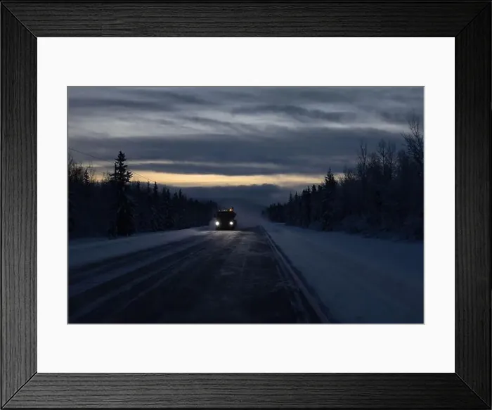 Framed Print : Snow blowing around truck driving on Richardson Highway on a dark winter morning in interior Alaska between Tok